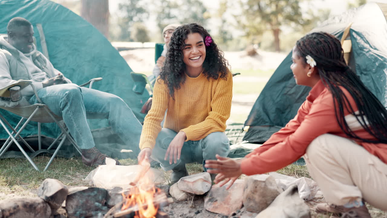 Friends camping around a campfire