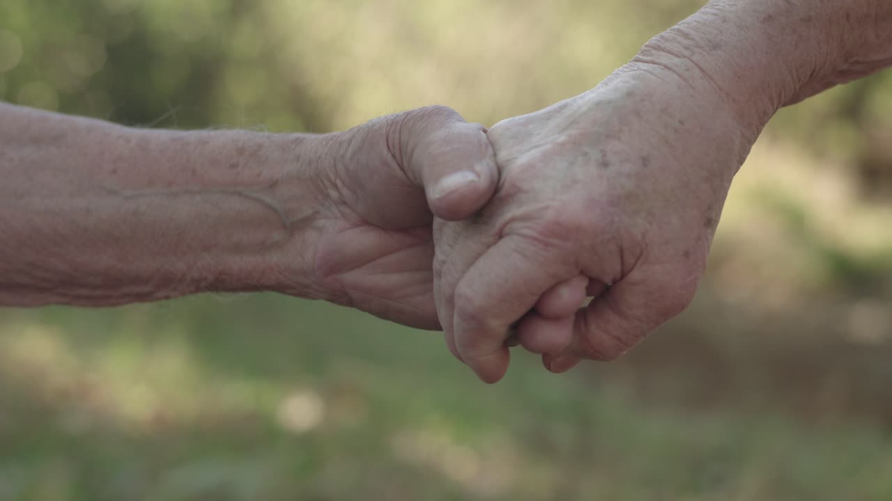 Elderly hands holding each other