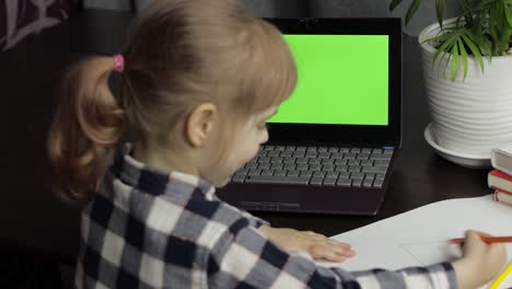 Children-distance-education-on-laptop-during-online-lesson-at-home.-Green-screen