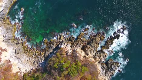 Hover-View-of-Unique-Rocky-Coastline-with-Ocean-Waves-Crashing