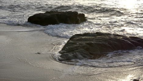 calming serenity, ocean swell over rocks at sunset, 4k