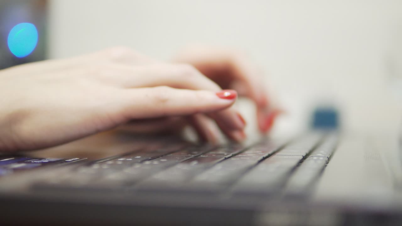 Woman's hands typing on computer. Closeup view