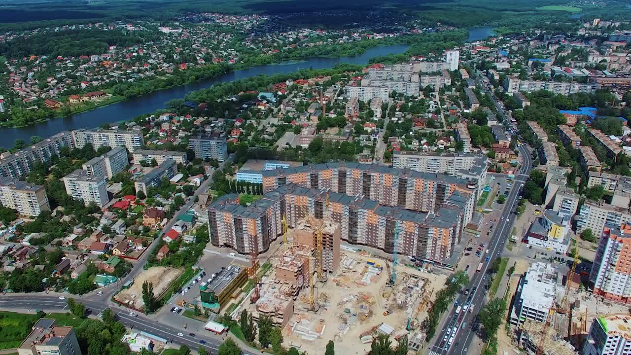 New architectural buildings in the downtown. Panoramic view of a city with a construction site of a modern district. Aerial view.
