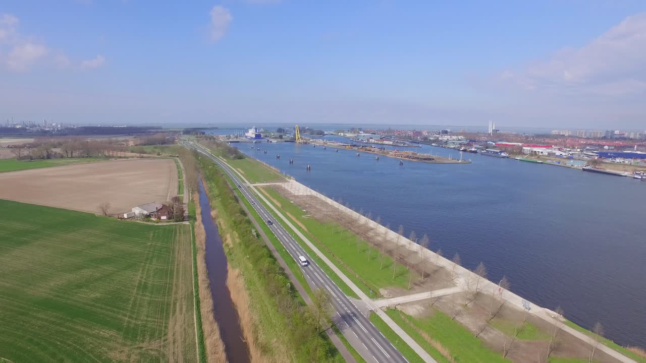 Aerial view of a river, road, and fields