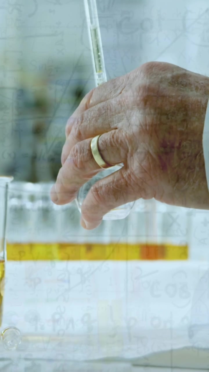 Animation of chemical formulas over hands of caucasian male lab worker