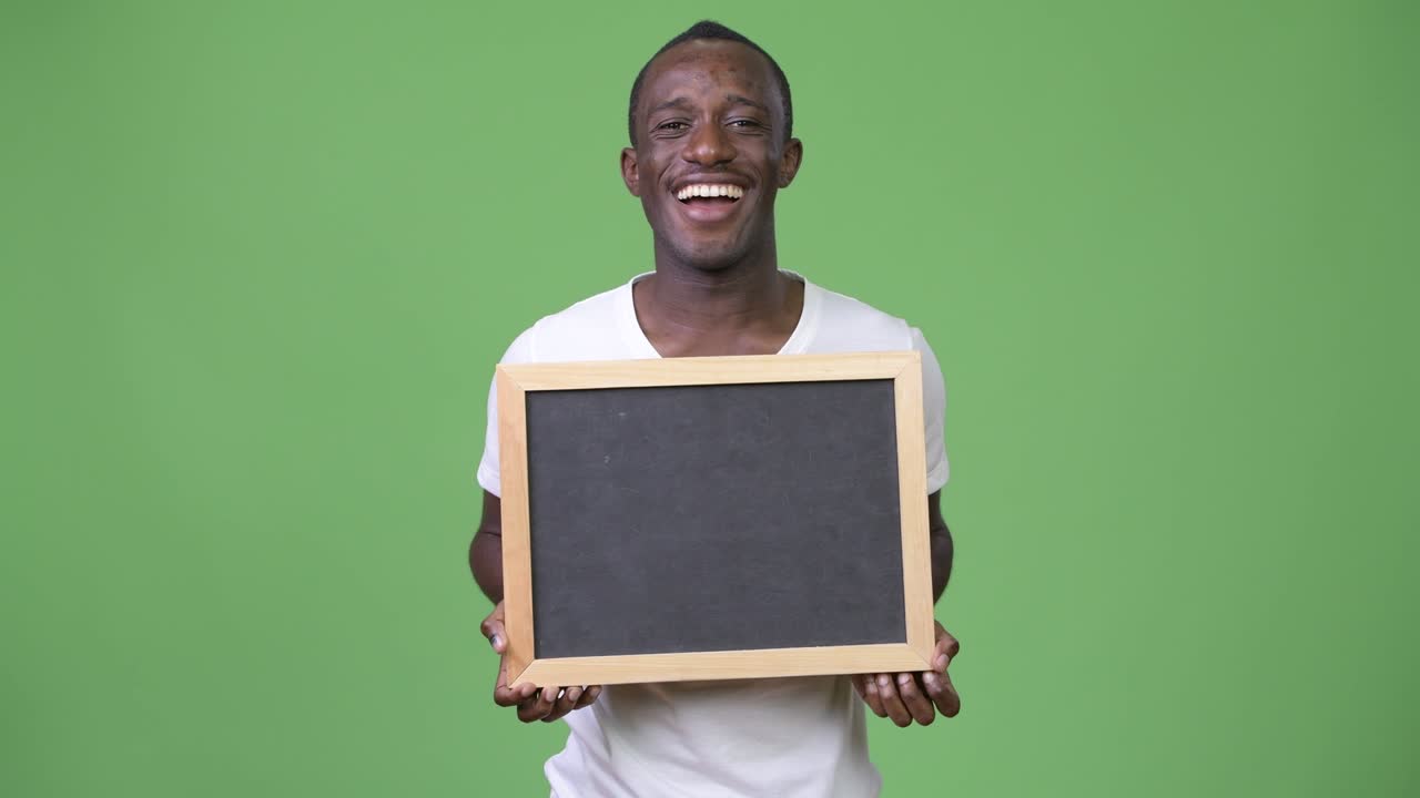 Young African man showing blackboard