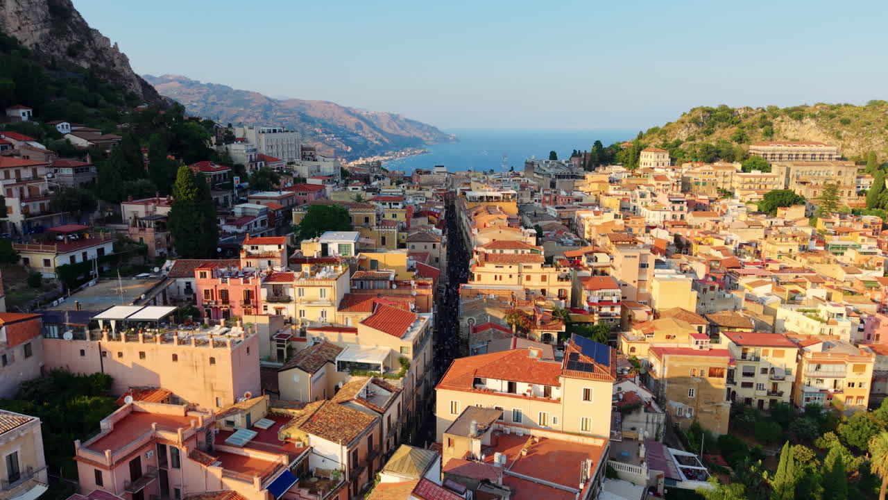 Vibrant rooftops of Taormina with sea view, evoking wanderlust and serenity