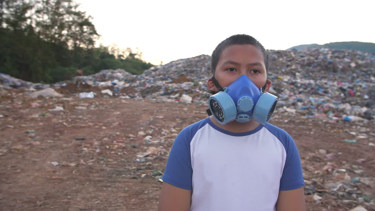 Asian Boy In Protective Mask Standing With Garbage Pile, Slow Motion