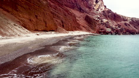 red sand beach, red volcanic sand, santorini greece, tourist destination, off season empty beach, blue waters, teal and orange