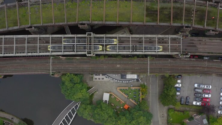 Overhead Drone Shot Tracking Train Travelling Through Castlefield Canals 04