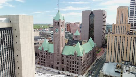 Drone-push-in-downtown-Minneapolis-towards-city-hall-clock-tower-on-a-spring-afternoon-4k