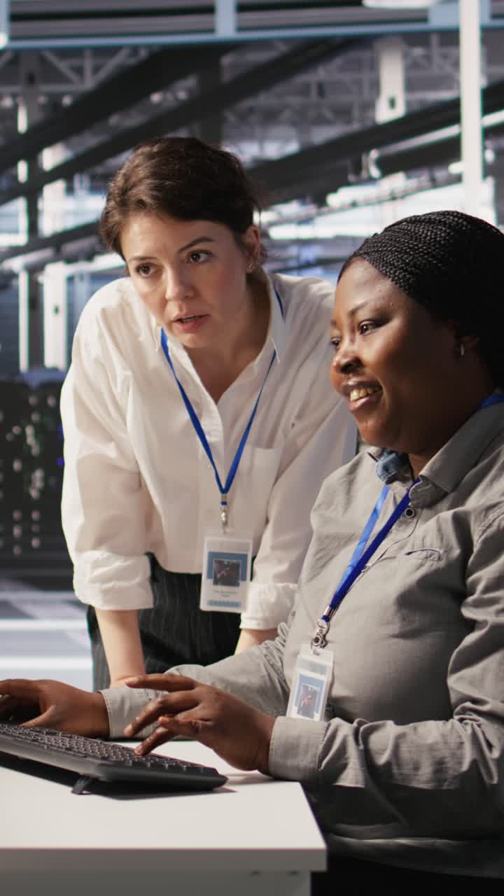 Vertical video Data center team leader and IT expert reviewing performance dashboards of AI