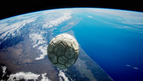 old soccer ball in space on earth orbit