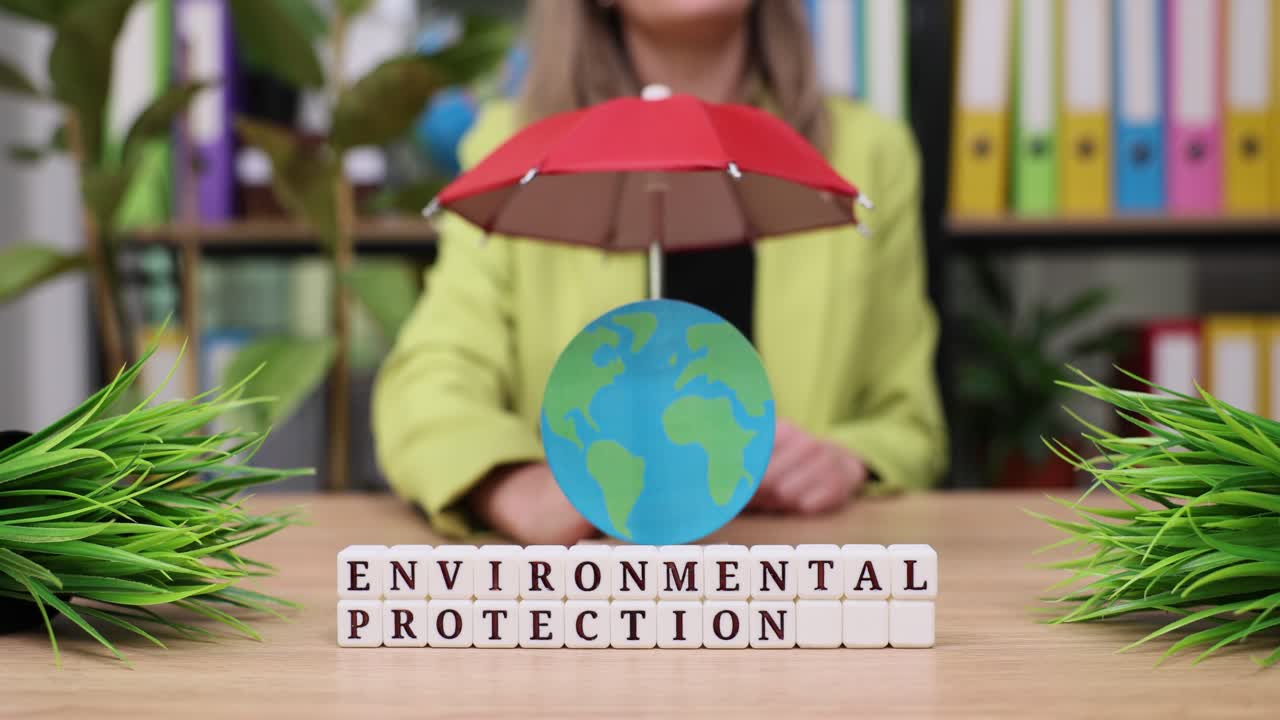 Environmental Protection Concept with Earth Globe and Umbrella