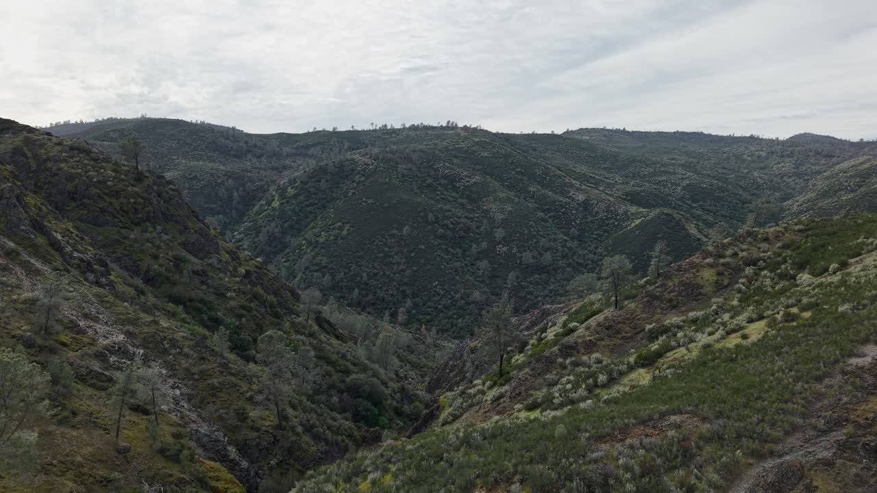 An aerial zoom out view of the rolling hills surrounding the Golden Chain Highway.