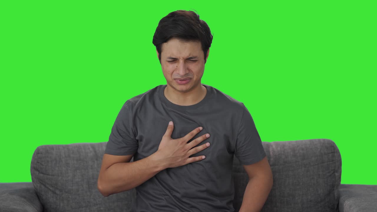 Sick Indian man suffering from acidity Green screen