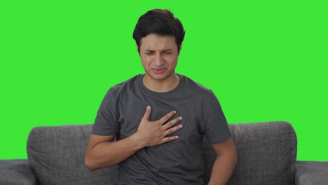 sick indian man suffering from acidity green screen