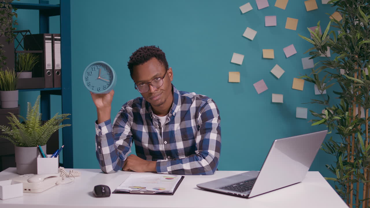Impatient man waiting to finish work and checking time on clock