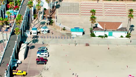 Oceanside-California-panning-left-close-up-view-of-the-Pier-beach-sand-surf-bike-path-and-hotels