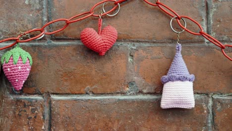 crochet keychains on brick wall