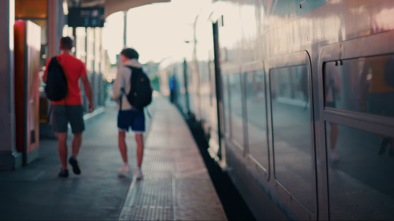 Blurry view of people and trains moving at the Nice Train Station