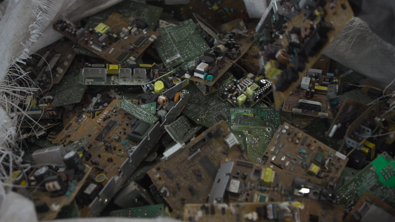 Gloved Hand Inspecting Electronic Boards Inside Woven Bag, Facility Technician Sorting Components, Closeup . Media