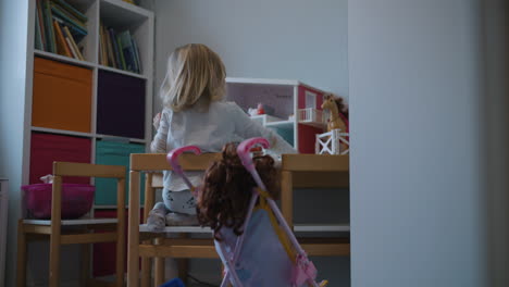 back of a little girl playing on her own in kids room