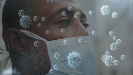 animación de células de covid-19 en primer plano de un hombre afroamericano con una máscara facial