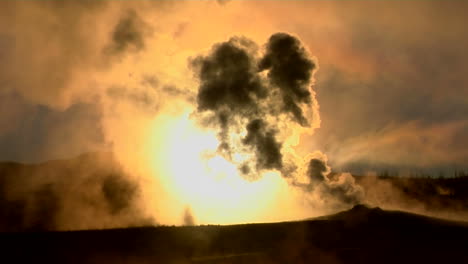 dark clouds rise from a volcanic eruption in a geothermal area of yellowstone national park 1