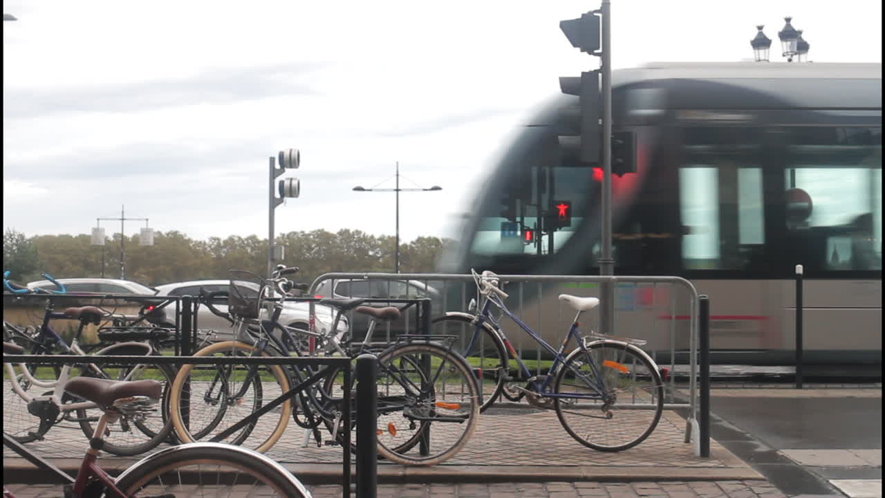 Street view with bicycles, traffic light, and a train