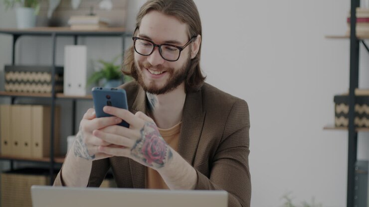 Man Working on Mobile Phone in Office