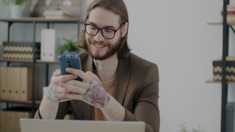 man working on mobile phone in office