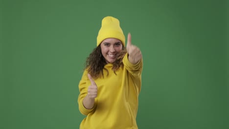 woman giving thumbs up over green screen