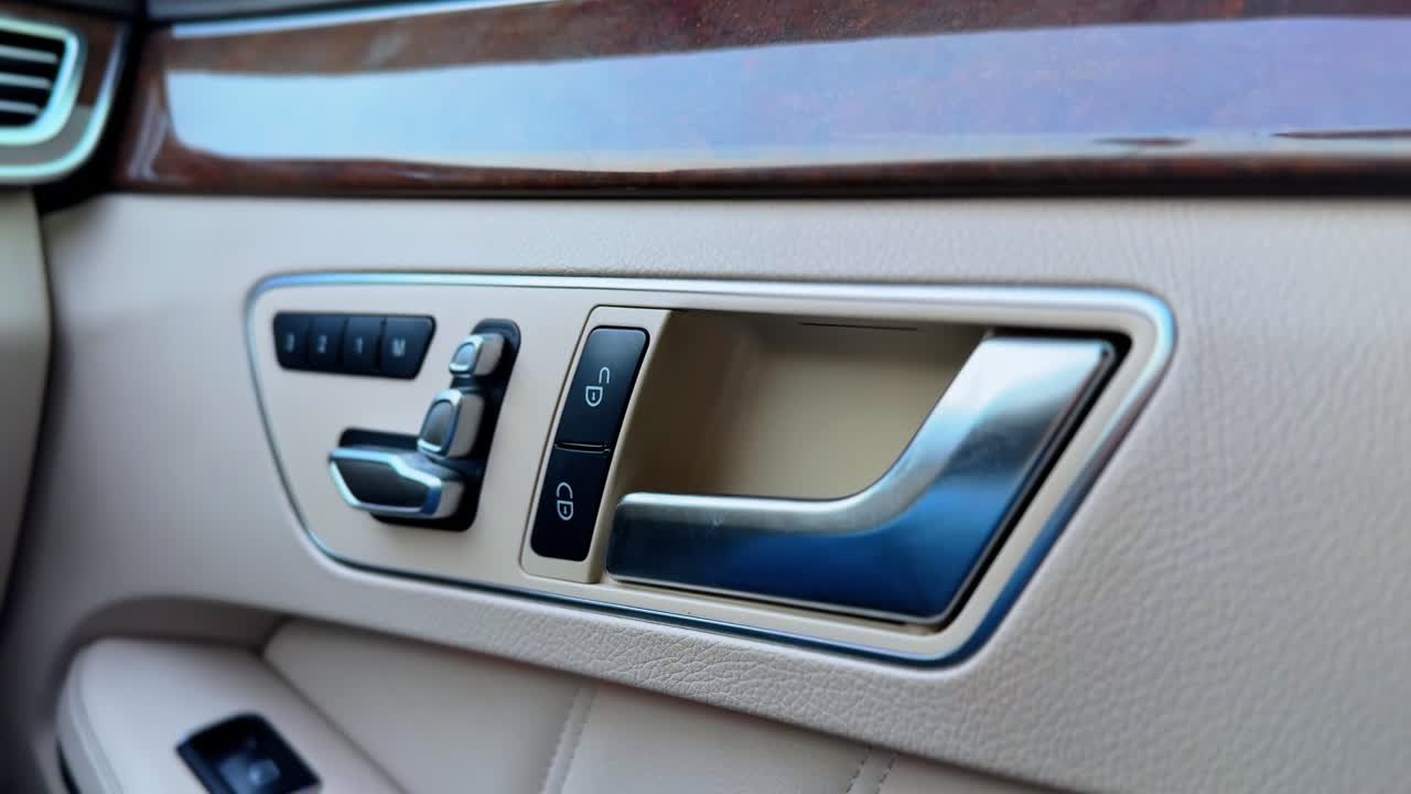 High-end car door handle with metallic detailing and button controls. Perfect for automobile interior, luxury lifestyle, or tech feature visuals.