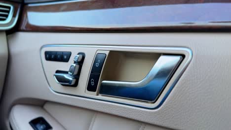 high-end car door handle with metallic detailing and button controls. perfect for automobile interior, luxury lifestyle, or tech feature visuals.