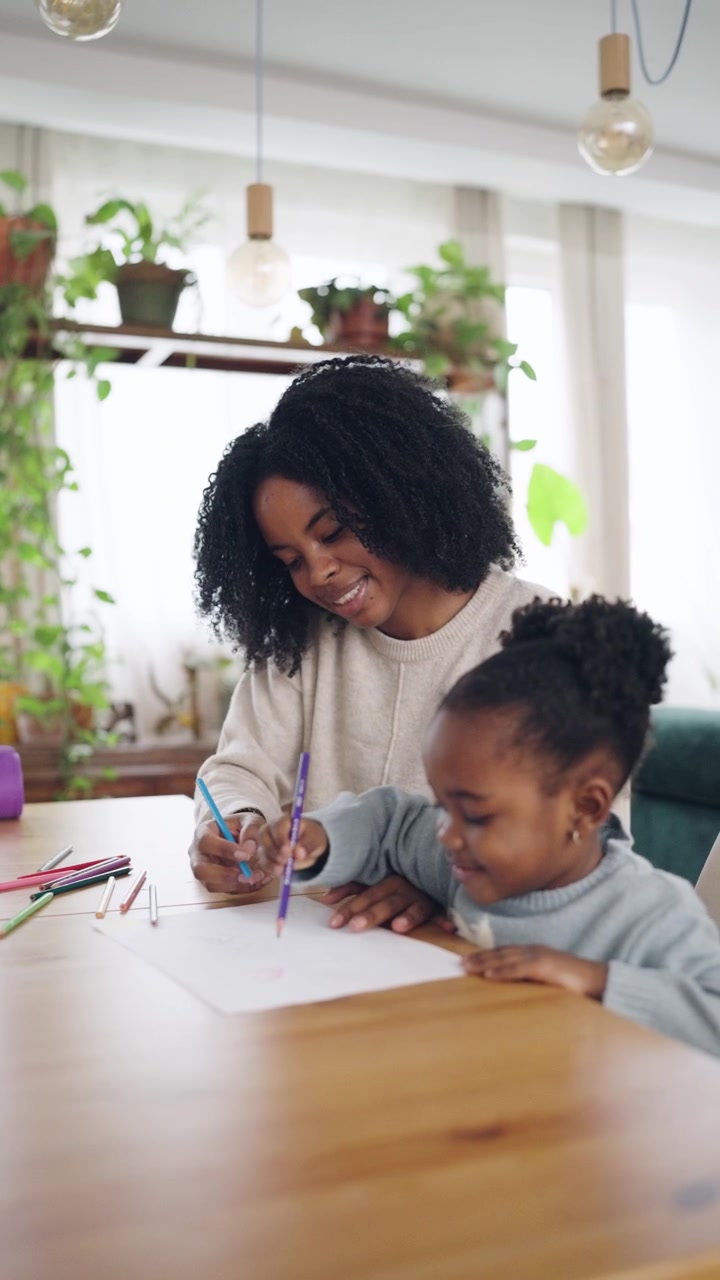 Smiling African American Mother and Child Drawing with Pencils