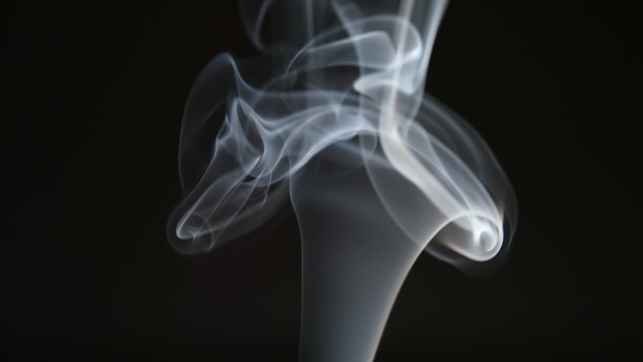 SLOW MOTION: Changing smoke curves on a black background