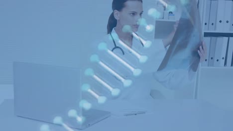 Animation-of-dna-strand-over-female-doctor-holding-x-ray-photograph