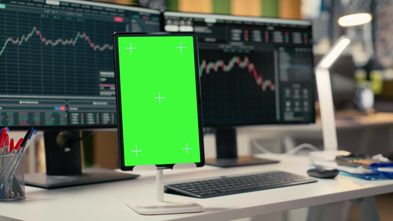 Close up of green screen tablet in brokerage company workplace