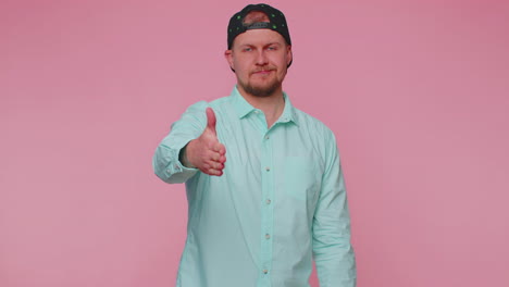 friendly man outstretching hand to camera, offering handshake, greeting with kind smile, welcoming