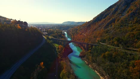 Stunning-aerial-4K-drone-footage-of-Solkan-arch-bridge-over-the-Soča-river,-a-majestic-stone-marvel-located-in-western-Slovenia