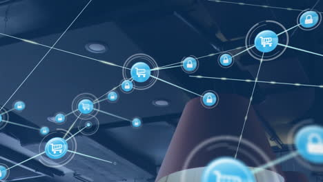 animación de una red de iconos digitales frente a la vista del techo de la oficina