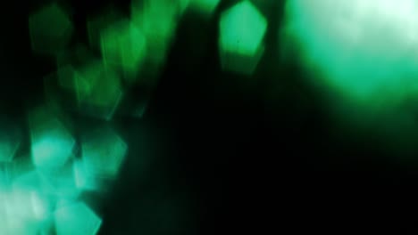 green light flashing on bottom left corner of screen covered with light reflections.