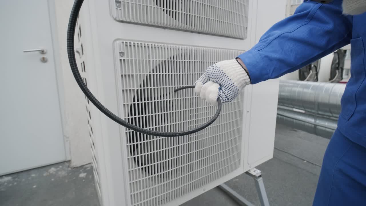 The technician uses a digital camera to check the clogging of the heat exchanger