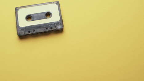 video of retro tape with yellow label with copy space on yellow background