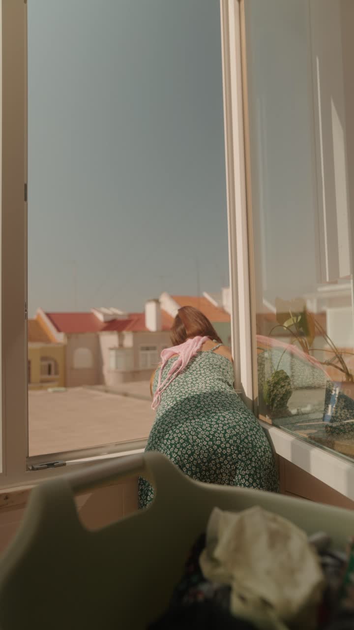 Woman Cleaning Window at Home