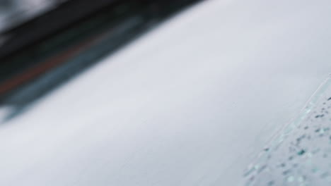 Macro-Close-Up-Shot-Of-Raindrops-Being-Cleared-From-Car-Windshield-By-Wipers