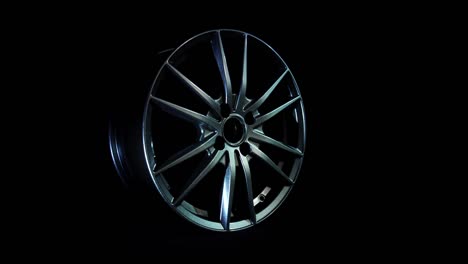 modern automotive alloy wheel made of aluminum on a black background, industry. designer fashion wheels for car, mechanic, copy space