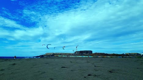 people surfing on magical sandy beach under blue sky in tenerife, spain