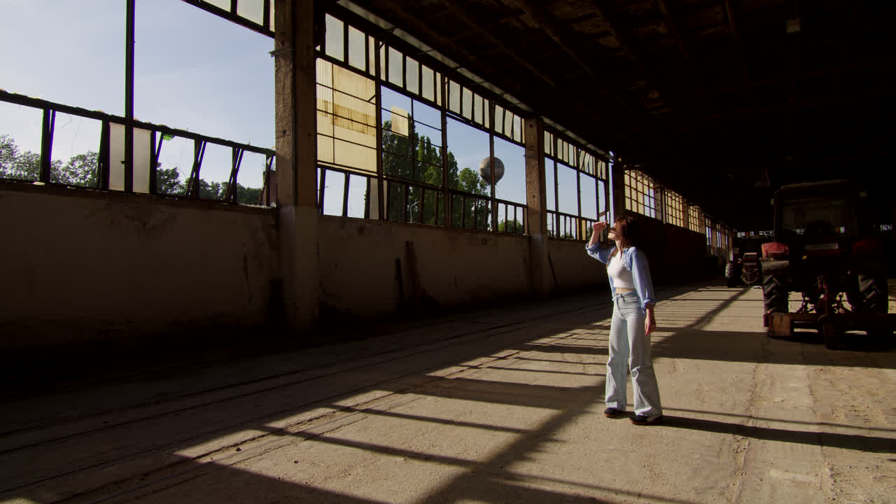 Woman Walking in an Abandoned Industrial Building